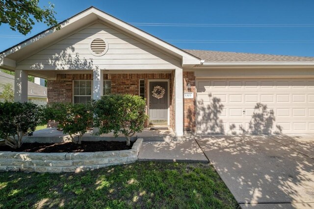 1303 Ridgewood Dr, Leander, TX 78641 - single story home featuring brick siding, concrete driveway, and an attached garage