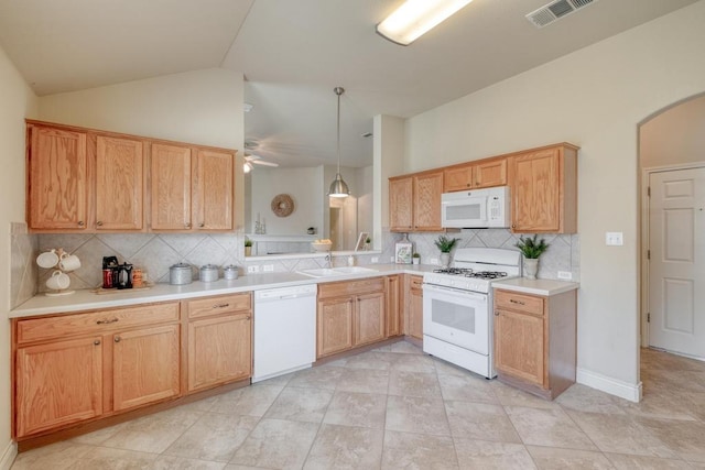 kitchen featuring white appliances, backsplash, arched walkways, ceiling fan, and a sink
