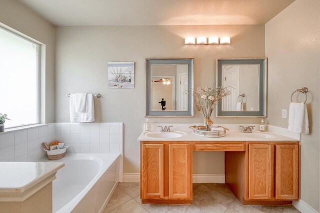 1303 Ridgewood Dr, Leander, TX 78641 - full bathroom featuring a bath, double vanity, and tile patterned floors