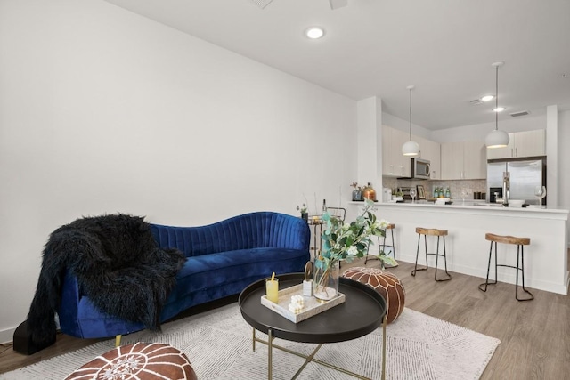 6324 N Lamar Blvd Unit 212, Austin, TX 78752 - living area with light wood-type flooring, recessed lighting, and baseboards
