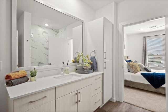 6324 N Lamar Blvd Unit 212, Austin, TX 78752 - ensuite bathroom with wood finished floors, vanity, and a marble finish shower