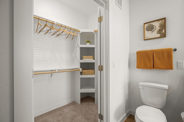 6324 N Lamar Blvd Unit 212, Austin, TX 78752 - bathroom featuring toilet and baseboards