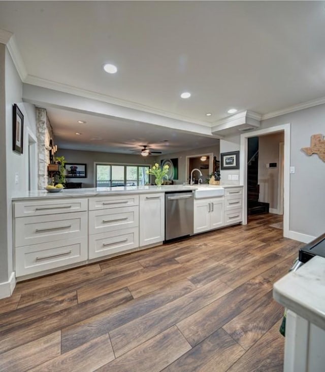 11408 Spicewood Pkwy, Austin, TX 78750 - kitchen featuring stainless steel dishwasher, ornamental molding, a peninsula, white cabinetry, and light countertops