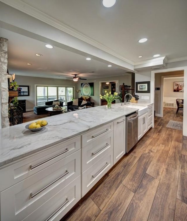 11408 Spicewood Pkwy, Austin, TX 78750 - kitchen with stainless steel dishwasher, recessed lighting, ornamental molding, white cabinets, and light stone counters
