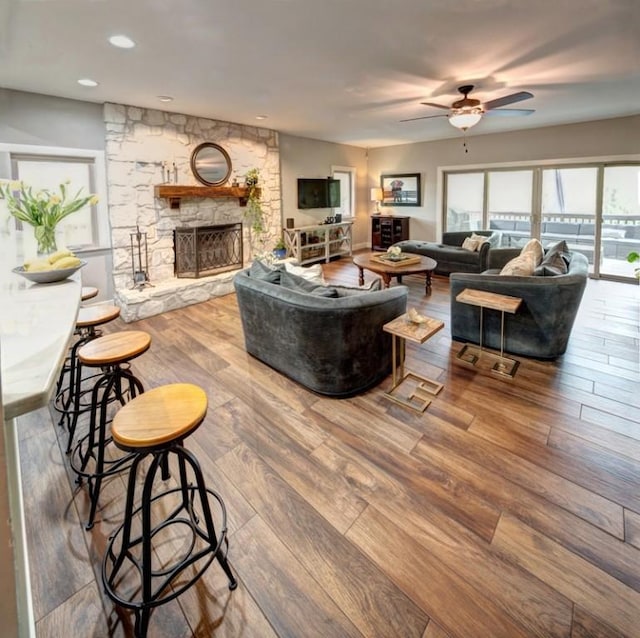11408 Spicewood Pkwy, Austin, TX 78750 - living area with hardwood / wood-style flooring, a fireplace, a ceiling fan, and recessed lighting