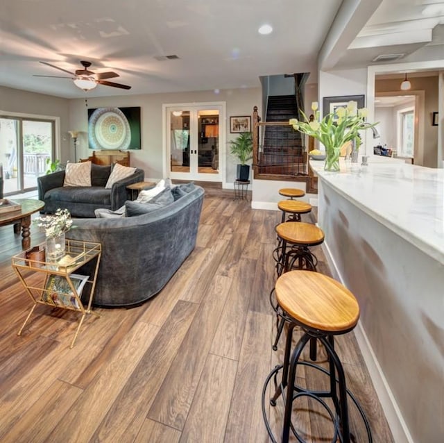 11408 Spicewood Pkwy, Austin, TX 78750 - living room with a ceiling fan, wood finished floors, and stairway