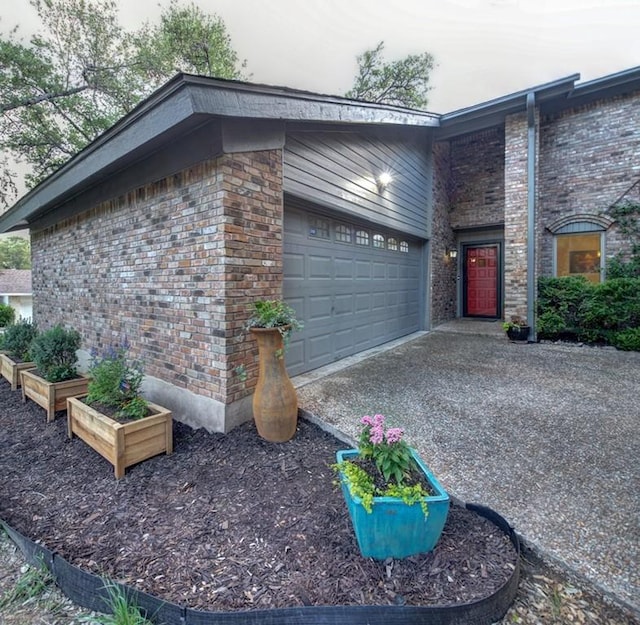 11408 Spicewood Pkwy, Austin, TX 78750 - view of home's exterior with driveway, brick siding, and an attached garage