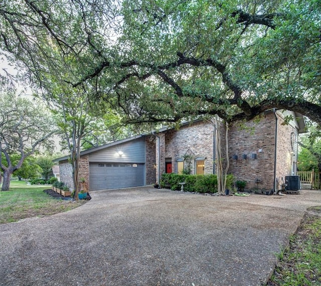 11408 Spicewood Pkwy, Austin, TX 78750 - view of front of property featuring driveway, an attached garage, and brick siding