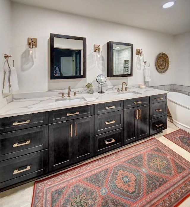11408 Spicewood Pkwy, Austin, TX 78750 - bathroom featuring double vanity, a freestanding tub, and recessed lighting