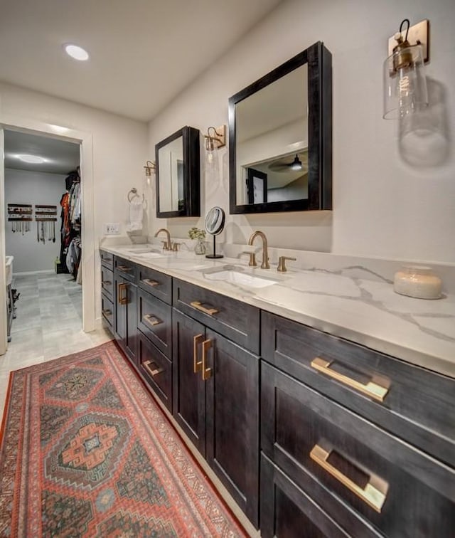 11408 Spicewood Pkwy, Austin, TX 78750 - bathroom with double vanity, a spacious closet, and recessed lighting