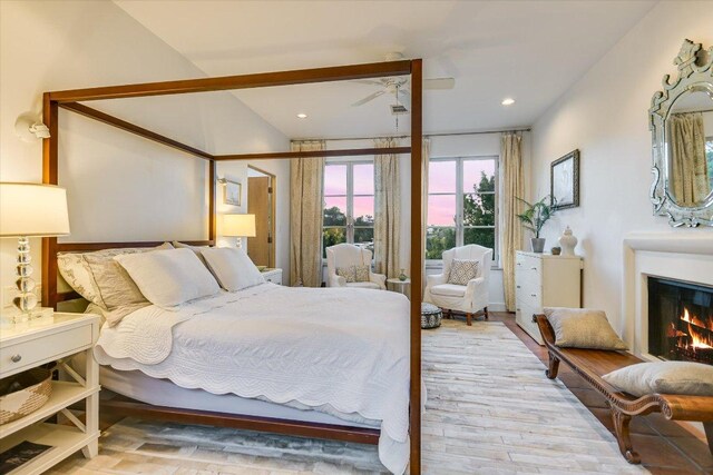 698 Windsong Trl, West Lake Hills, TX 78746 - bedroom featuring wood finished floors, recessed lighting, and a lit fireplace