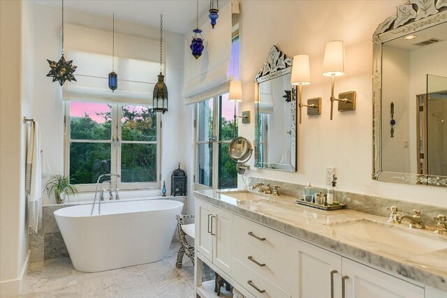 698 Windsong Trl, West Lake Hills, TX 78746 - full bath featuring a freestanding tub, marble finish flooring, double vanity, and french doors