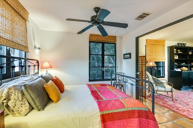 698 Windsong Trl, West Lake Hills, TX 78746 - tiled bedroom featuring multiple windows