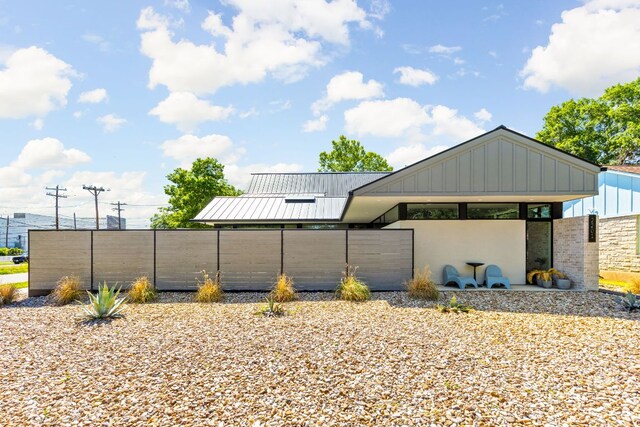 view of home's community featuring fence