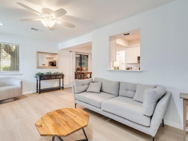 421 W San Antonio St Unit F1, San Marcos, TX 78666 - living room with light wood finished floors, a ceiling fan, and baseboards