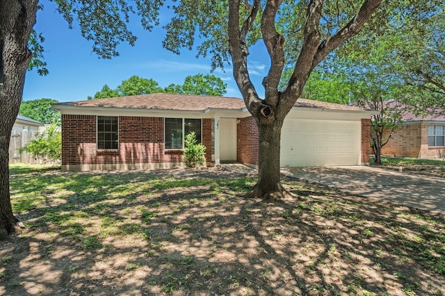 141 Britni Loop, Kyle, TX 78640 - ranch-style home featuring a garage, driveway, and brick siding