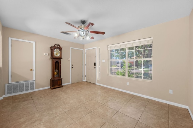141 Britni Loop, Kyle, TX 78640 - spare room featuring a ceiling fan, light tile patterned floors, and baseboards