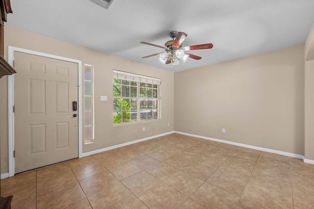 141 Britni Loop, Kyle, TX 78640 - entryway featuring ceiling fan, light tile patterned floors, and baseboards