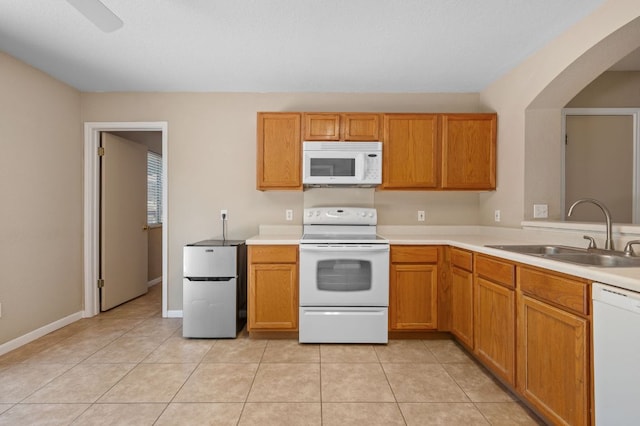 141 Britni Loop, Kyle, TX 78640 - kitchen featuring white appliances, a sink, light countertops, and light tile patterned floors