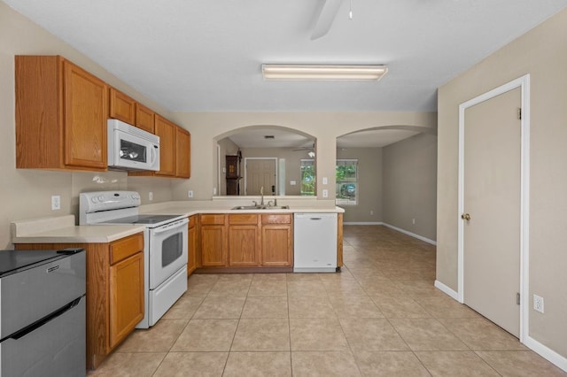 141 Britni Loop, Kyle, TX 78640 - kitchen featuring white appliances, a ceiling fan, a sink, and light countertops