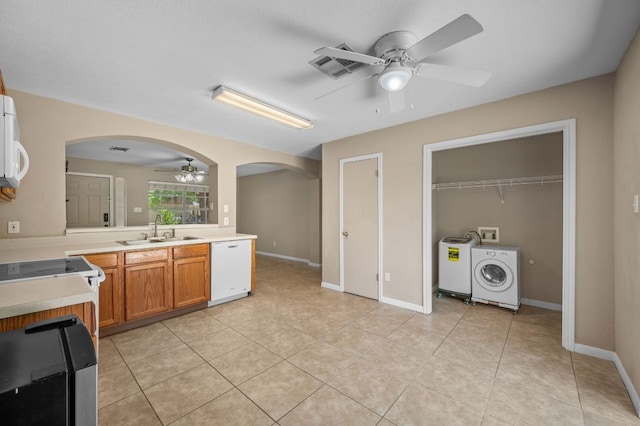 141 Britni Loop, Kyle, TX 78640 - kitchen with a ceiling fan, a sink, washer / clothes dryer, white appliances, and arched walkways