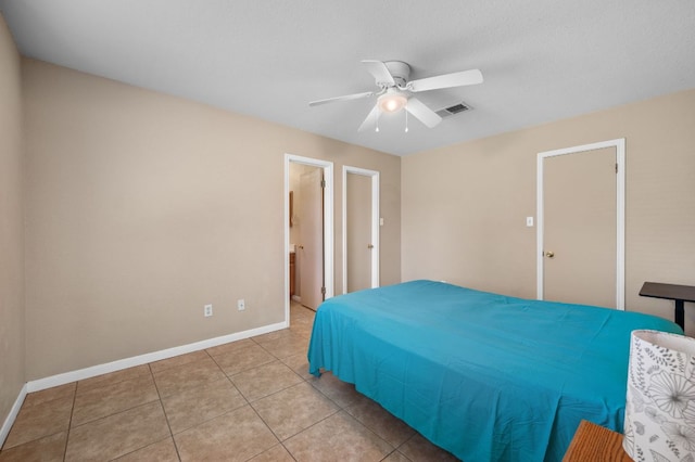 141 Britni Loop, Kyle, TX 78640 - bedroom with light tile patterned floors, baseboards, and ceiling fan