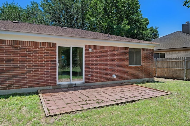 141 Britni Loop, Kyle, TX 78640 - rear view of property featuring brick siding and a patio