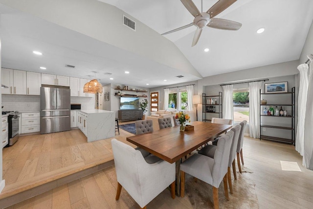 1302 Astor Pl, Austin, TX 78721 - dining room with lofted ceiling, light wood finished floors, a ceiling fan, and recessed lighting