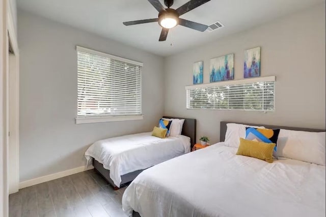 bedroom with wood finished floors, baseboards, and ceiling fan