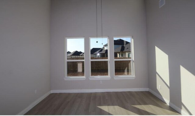 11804 Shimmering Sea Dr, Austin, TX 78747 - unfurnished dining area with wood finished floors and baseboards