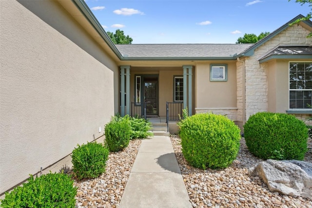 138 Dewberry Dr, Georgetown, TX 78633 - property entrance featuring stone siding, stucco siding, covered porch, and a shingled roof