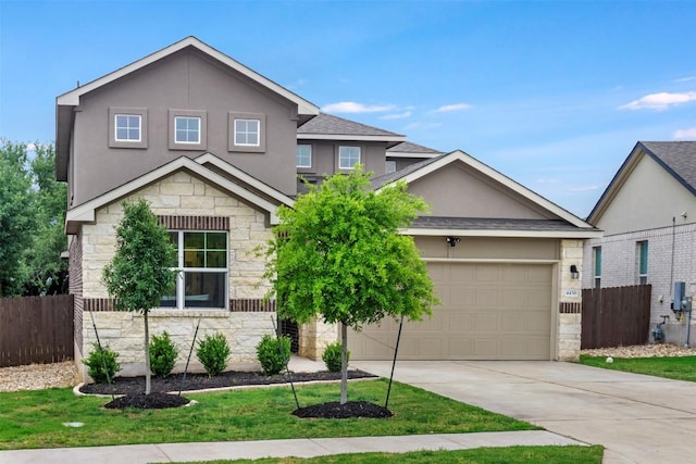 view of front of house with stone siding, fence, driveway, stucco siding, and a garage