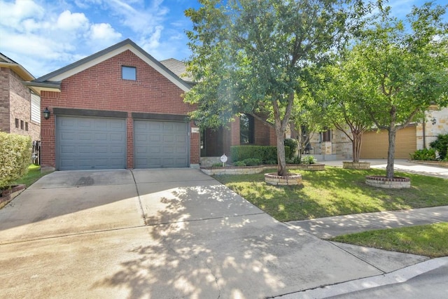 441 Cascada Ln, Round Rock, TX 78681 - view of front facade with brick siding, driveway, a front yard, and a garage