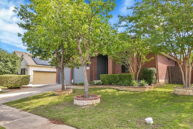 view of property hidden behind natural elements with brick siding and driveway