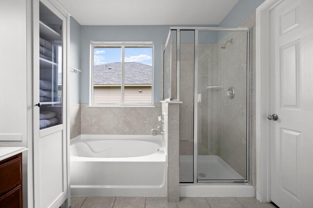 7613 Buck Meadow Dr, Georgetown, TX 78628 - bathroom with a bath, a stall shower, tile patterned flooring, and vanity