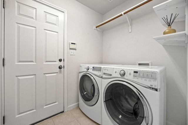 7613 Buck Meadow Dr, Georgetown, TX 78628 - laundry room featuring separate washer and dryer, light tile patterned floors, and baseboards