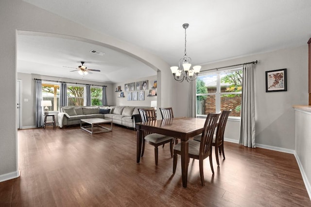 7613 Buck Meadow Dr, Georgetown, TX 78628 - dining area featuring dark wood-style flooring, a chandelier, baseboards, ceiling fan, and arched walkways