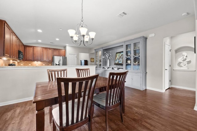 7613 Buck Meadow Dr, Georgetown, TX 78628 - dining space with a chandelier, recessed lighting, dark wood-style flooring, and baseboards