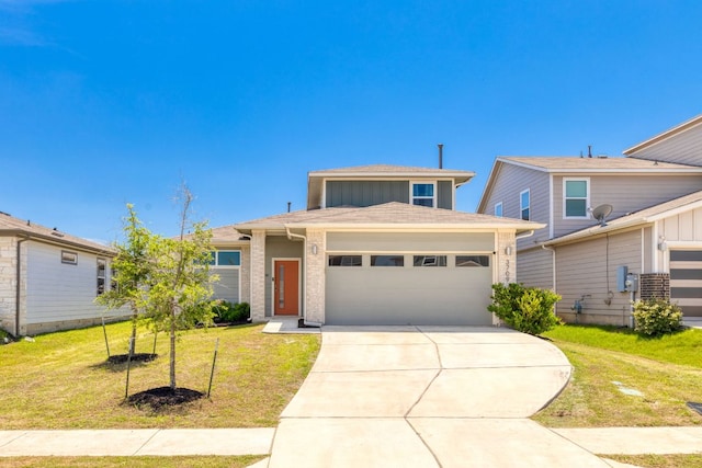 view of front of house with an attached garage, a front yard, and driveway