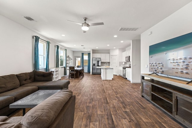 living room featuring dark wood-style floors, a ceiling fan, and recessed lighting
