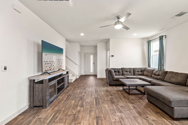living area with dark wood-style flooring, a ceiling fan, stairway, baseboards, and recessed lighting