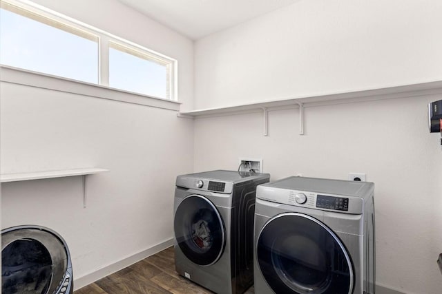 laundry room featuring washer and clothes dryer, dark wood-style flooring, and baseboards