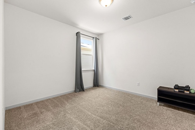 carpeted spare room with baseboards