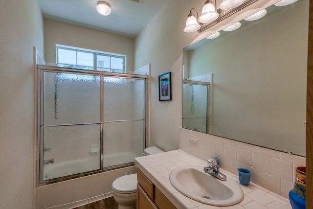 521 E Briarway Dr, Granite Shoals, TX 78654 - full bath featuring toilet, bath / shower combo with glass door, vanity, and backsplash
