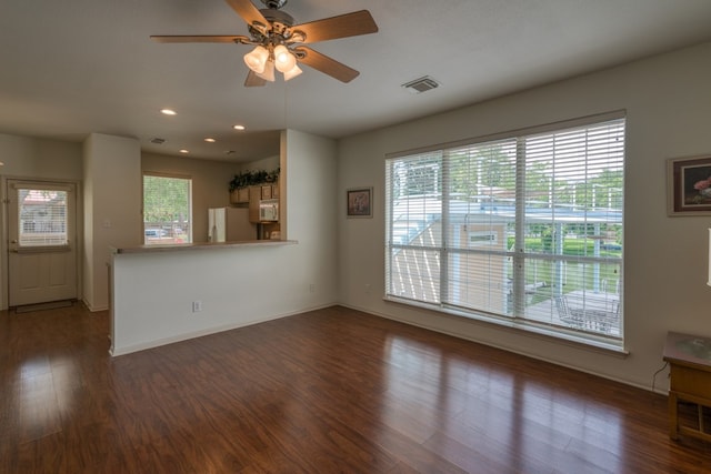 521 E Briarway Dr, Granite Shoals, TX 78654 - unfurnished living room with dark wood-type flooring, a ceiling fan, baseboards, and recessed lighting
