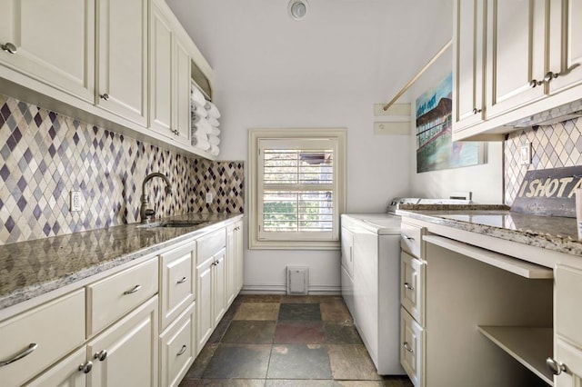 5902 Saratoga Cv, Austin, TX 78746 - washroom featuring cabinet space, dark stone finish floors, and independent washer and dryer