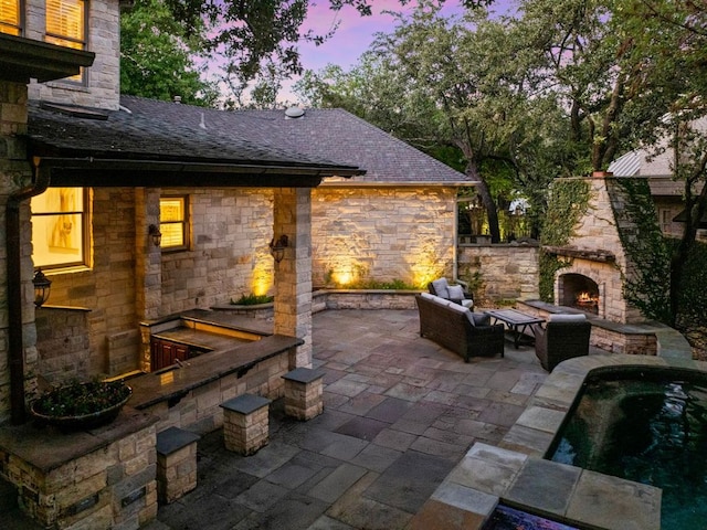 5902 Saratoga Cv, Austin, TX 78746 - patio terrace at dusk with a patio area and an outdoor living space with a fireplace