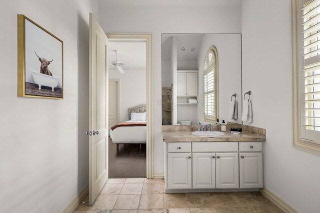 5902 Saratoga Cv, Austin, TX 78746 - bathroom featuring plenty of natural light, connected bathroom, vanity, and ceiling fan