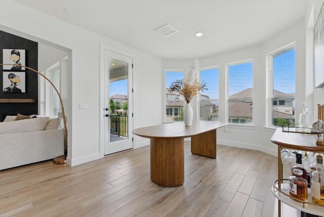 dining space featuring light wood finished floors, baseboards, and recessed lighting