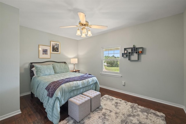 bedroom with hardwood / wood-style floors, baseboards, and a ceiling fan